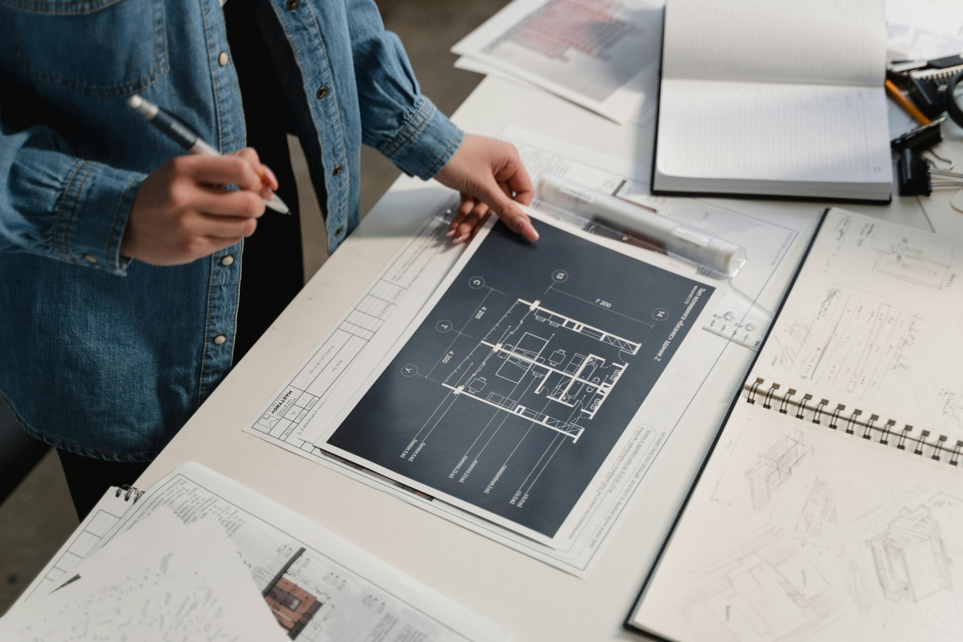 Architect reviewing building blueprints on a table